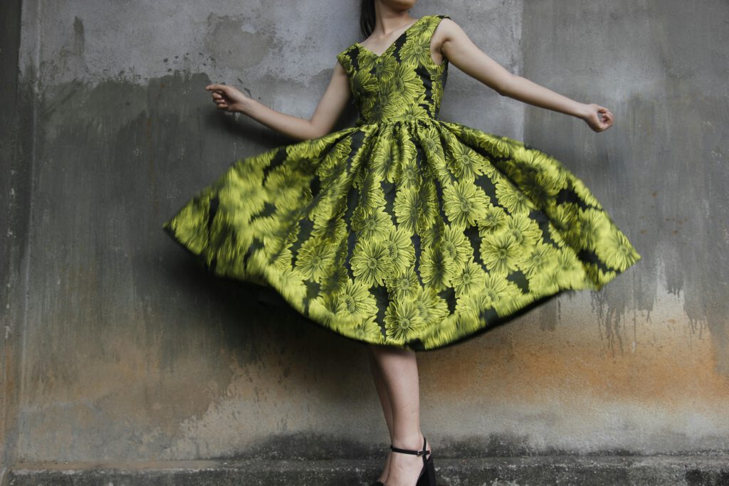 pexels-photo-985635-985635 Woman twirling in a vibrant floral dress capturing movement and style.